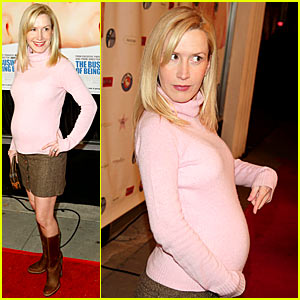 Mom-to-be Angela Kinsey points out the obvious, showing off her baby bump at