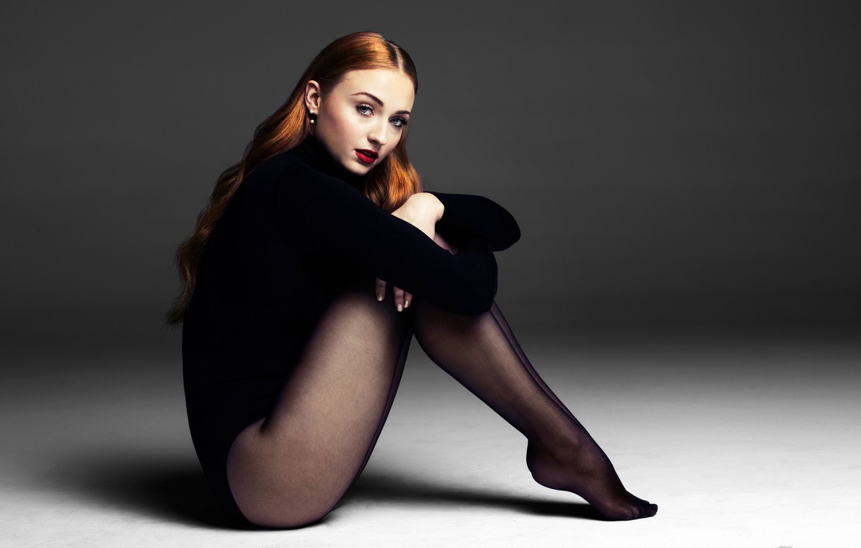 Sophie Turner sits on the floor in a bodysuit and tights